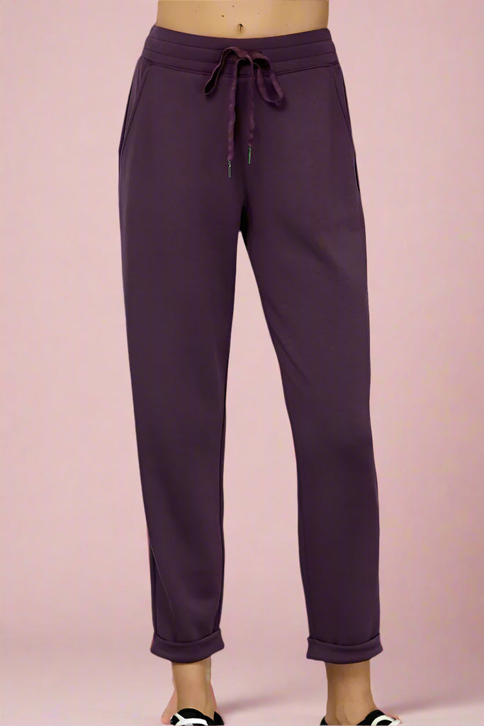 Buttery soft plum colored joggers with side pockets, a tapered leg, and tie waist. 