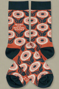 High patterned navy and orange socks that say “Wore my big girl socks.”