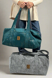 A duffel bag in blue dream or slate croc pattern. Made by New Hope Girls.