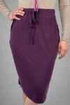 A women’s relaxed fit pencil style skirt in eggplant purple with elastic tie waist and tulip hem.