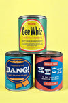 3 different scented 12 ounce candles in mini vintage style paint cans. Each “paint can” has an old-time saying printed on it.