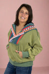 A women’s hooded sweatshirt in a sage green color with contrasting knit hood and neckline.