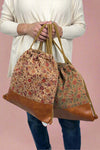 Drawstring cinch bag made of cork with unique multicolor floral design. 