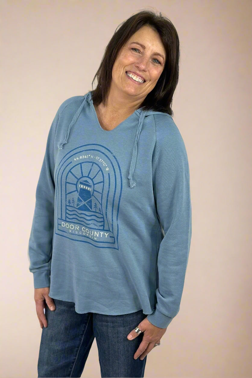 A Door County Hoodie in blue. This has a graphic featuring Door County coordinates and a lighthouse and a v-neckline. 