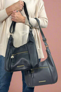 Shoulder bag with adjustable strap that can transition to crossbody. Gold hardware with small zipper pocket on front panel. 