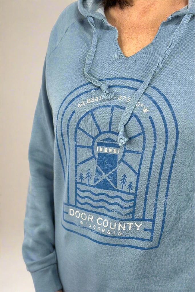 A Door County Hoodie in blue. This has a graphic featuring Door County coordinates and a lighthouse and a v-neckline. 