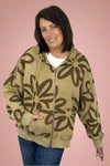 A women’s long sleeve zip up hoodie in a rich tan color featuring oversized fit and bold floral print in brown.