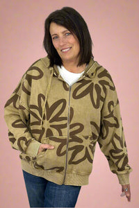 A women’s long sleeve zip up hoodie in a rich tan color featuring oversized fit and bold floral print in brown.