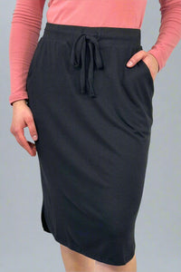 A women’s relaxed fit pencil style skirt in black with elastic tie waist and tulip hem.