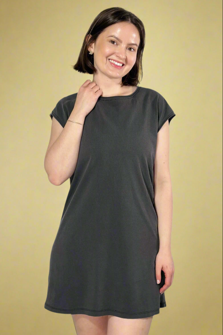 Model is wearing a sleeveless black mini dress