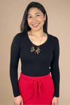 A women’s basic fitted long sleeve v-neck tee in black.
