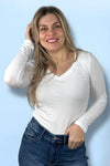 A women’s basic fitted long sleeve v-neck  tee in white.