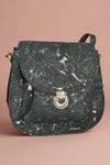 Black cork crossbody with flap front and gold marbling detail on the cork.