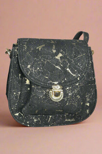 Black cork crossbody with flap front and gold marbling detail on the cork.