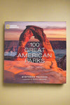 The cover of 100 Great American Parks by Stephanie Pearson with a forward by Garth Brooks.