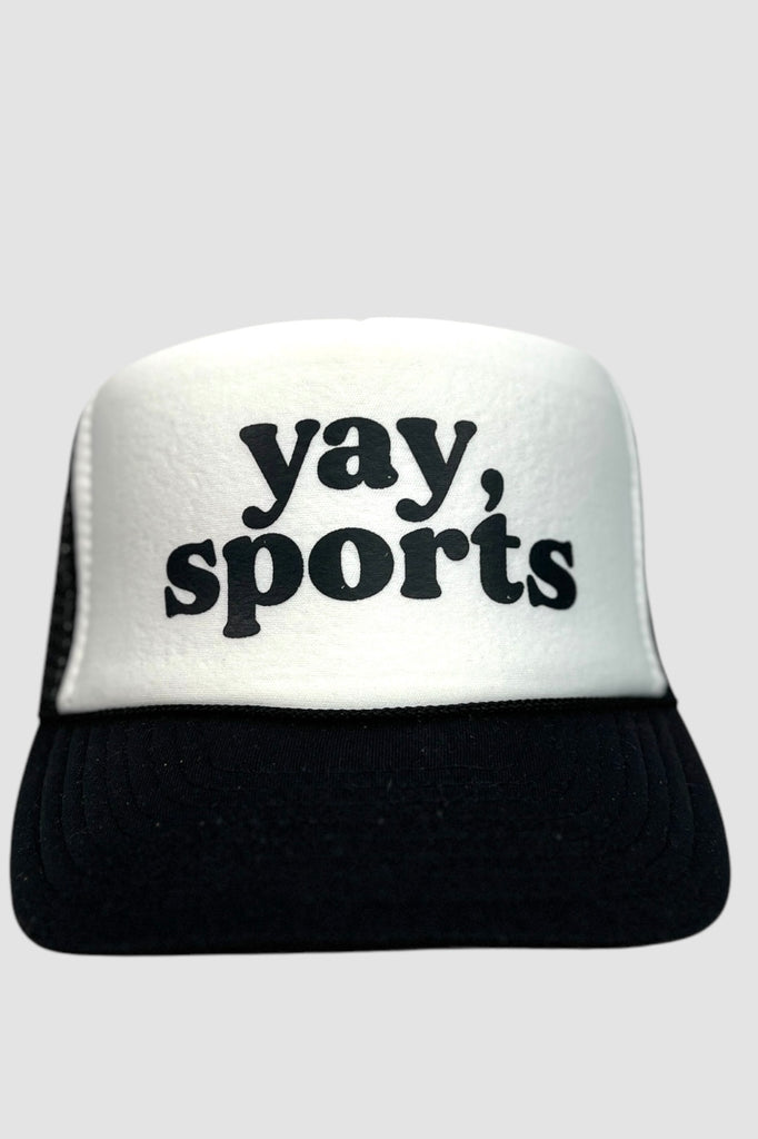 Black and white foam front trucker hat with the phrase "yay, sports" printed in black lettering. 