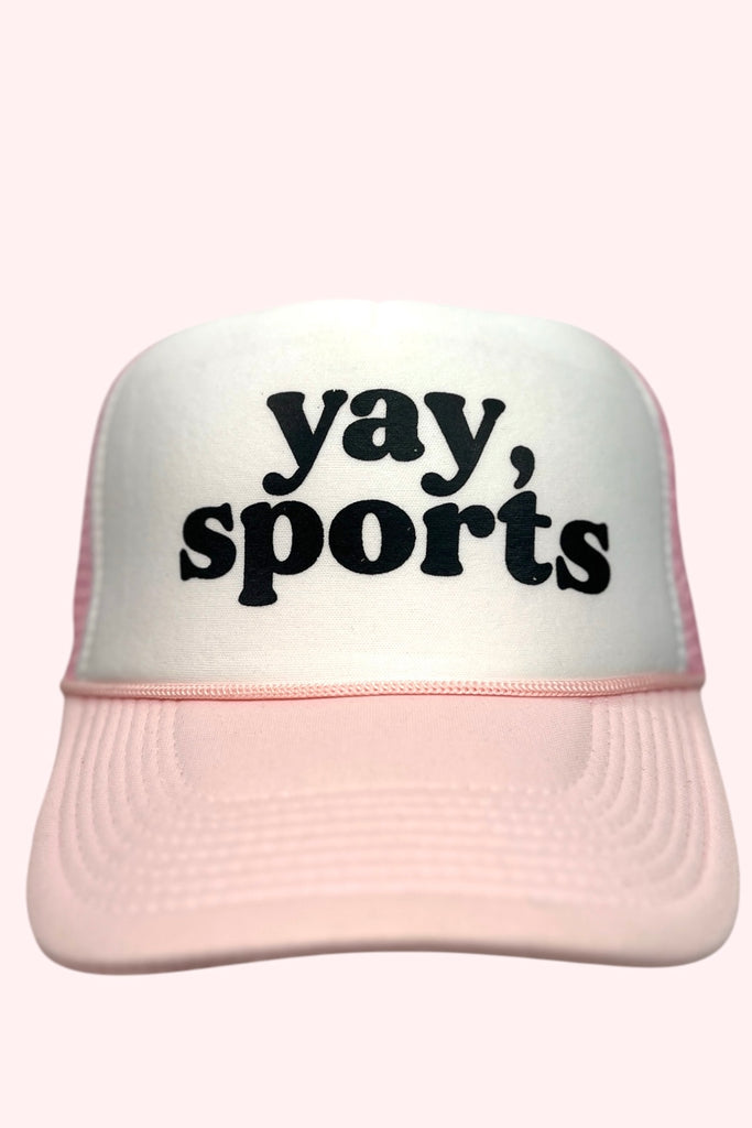 Pink and white foam front trucker hat with the phrase "yay, sports" printed in black lettering. 