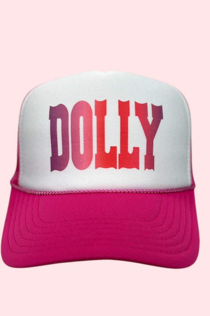 Pink and white foam front trucker hat with "DOLLY" printed across the front in pink western lettering. 