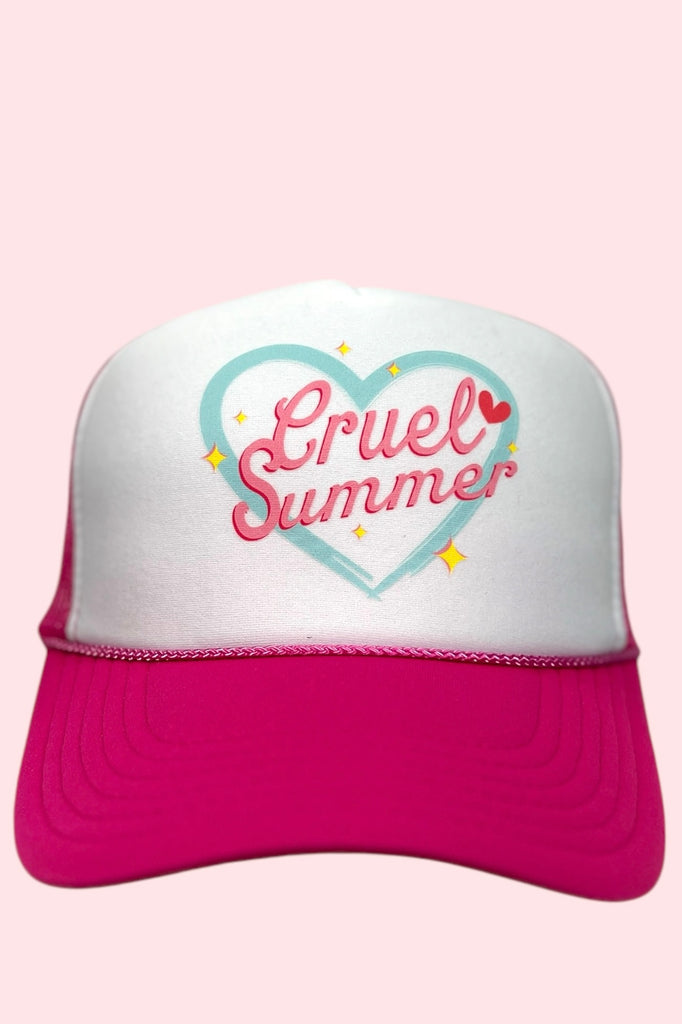 Pink and white foam front trucker hat with the phrase "cruel summer" printed across the front with a heart around it. 