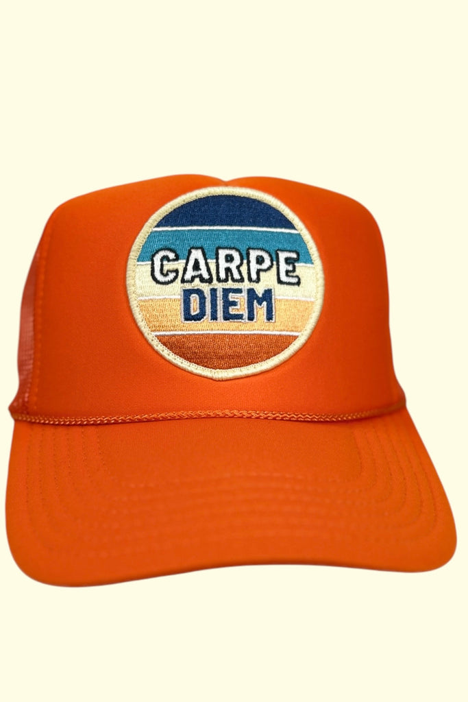 Orange colored trucker hat with a colorful patch that says "CARPE DIEM" on the front panel.