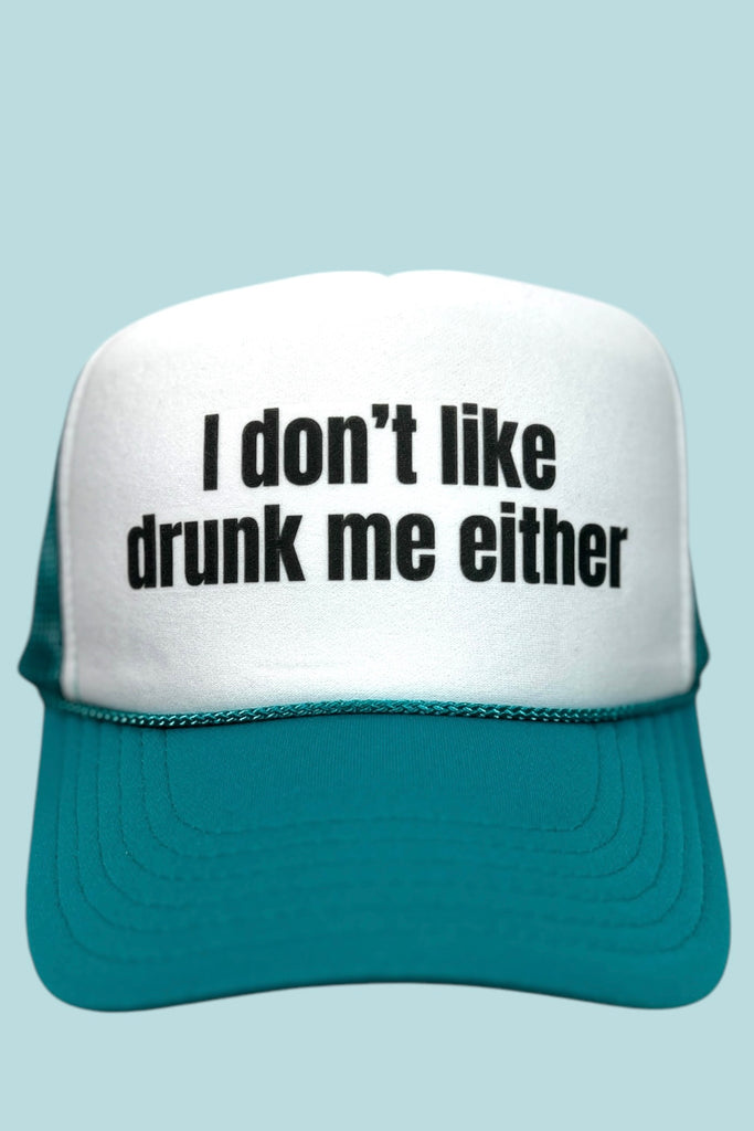 Teal and white foam front trucker hat with the phrase "I don't like drunk me either" printed across the front panel. 