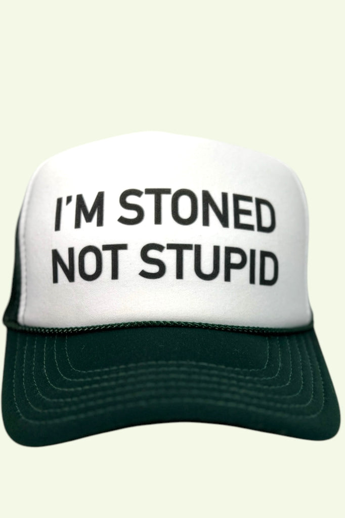 Green and white foam front trucker hat with "I'M STONED NOT STUPID" printed across the front in bold black lettering. 