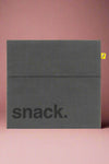 A reusable, Velcro close snack bag in the color dusk.