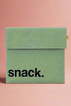A reusable, Velcro closure snack bag in the color moss.