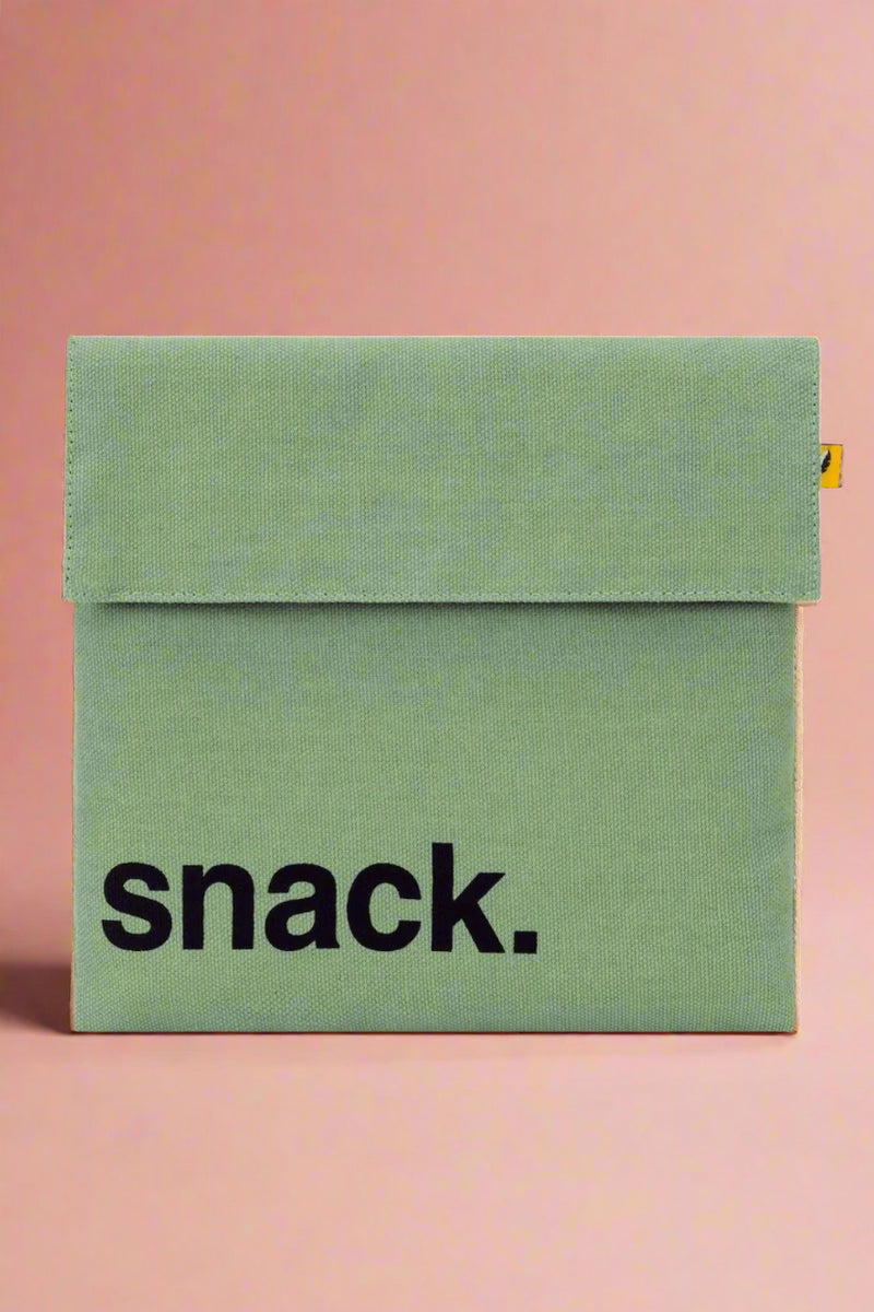 A reusable, Velcro closure snack bag in the color moss.