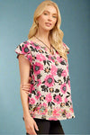 A floral pattern tunic with flutter sleeves and embroidery around the hem.