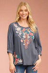 This charcoal blouse has 3/4 length sleeves and a round neckline. It is lightweight and features embroidered floral pattern.