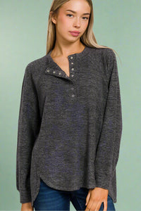 A women’s lightweight knit henley top in dark heather grey featuring a relaxed fit and high-low scoop hem.