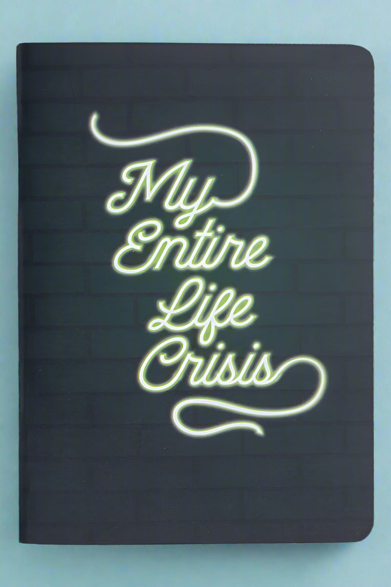 A small pocket notebook that says ‘My Entire Life Crisis’ on the front.