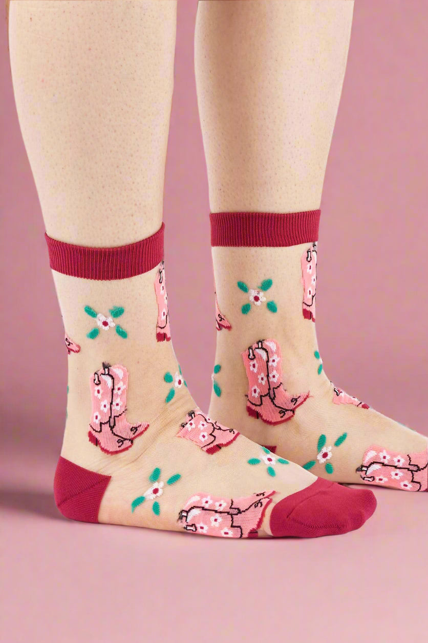 Socks with pink cowgirl design on beige background