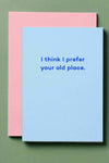 A minimalist greeting card in light blue with dark blue text that reads ‘I think I prefer your old place.’ Light pink envelope included.