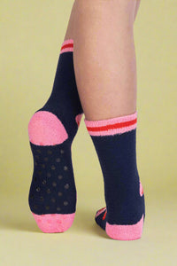 Navy socks with pink accents worn by a person on a light gray background