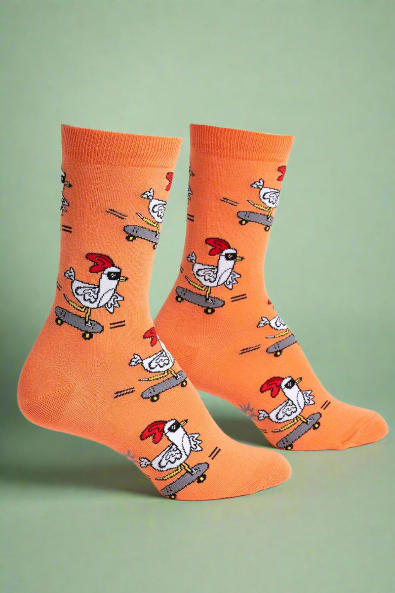 Orange socks with chicken designs on a white background