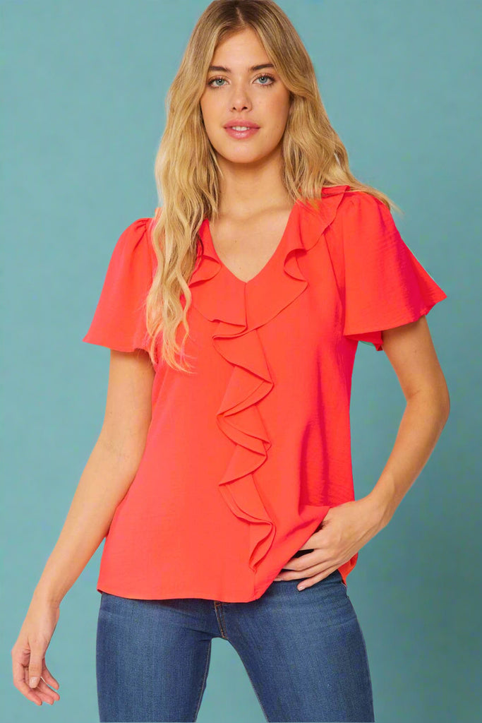 Flowy Neon Orange top with front ruffle. Short sleeve, flattering and easy to dress up or down. 