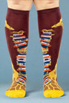 Knee-high socks with book and giraffe design on a white background