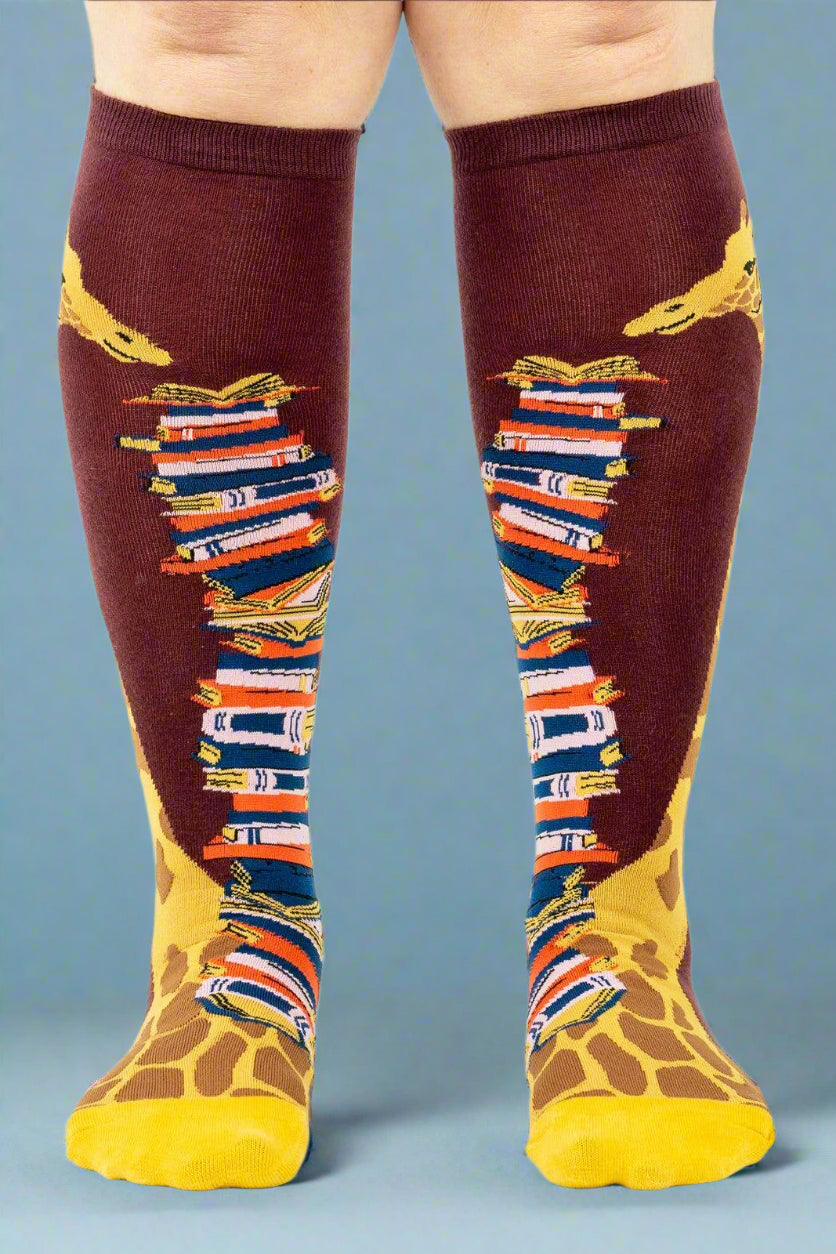 Knee-high socks with book and giraffe design on a white background