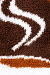 Close-up of a brown and white patterned rug with a snake design.