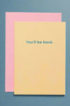 A yellow card with the words “You’ll be back.”