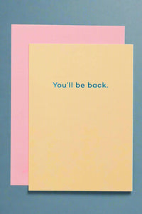 A yellow card with the words “You’ll be back.”