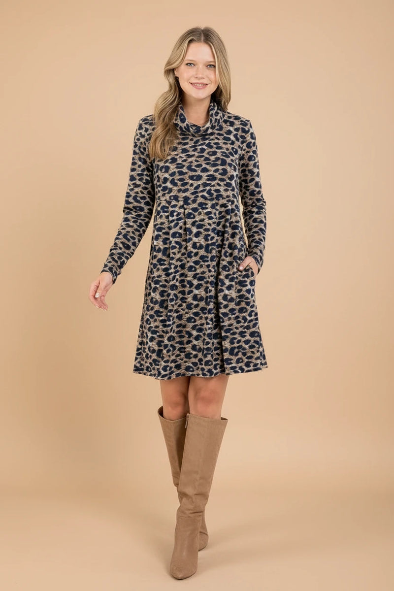 Woman wearing a leopard print dress in a minimalistic room.