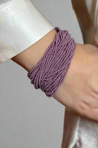 A purple, beaded chunky bracelet.