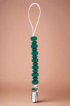 A beaded silicone Teether in green that is also a pacifier clip.