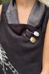 A gold or silver octagon shaped pin.