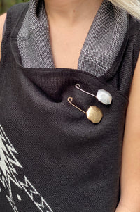 A gold or silver octagon shaped pin.