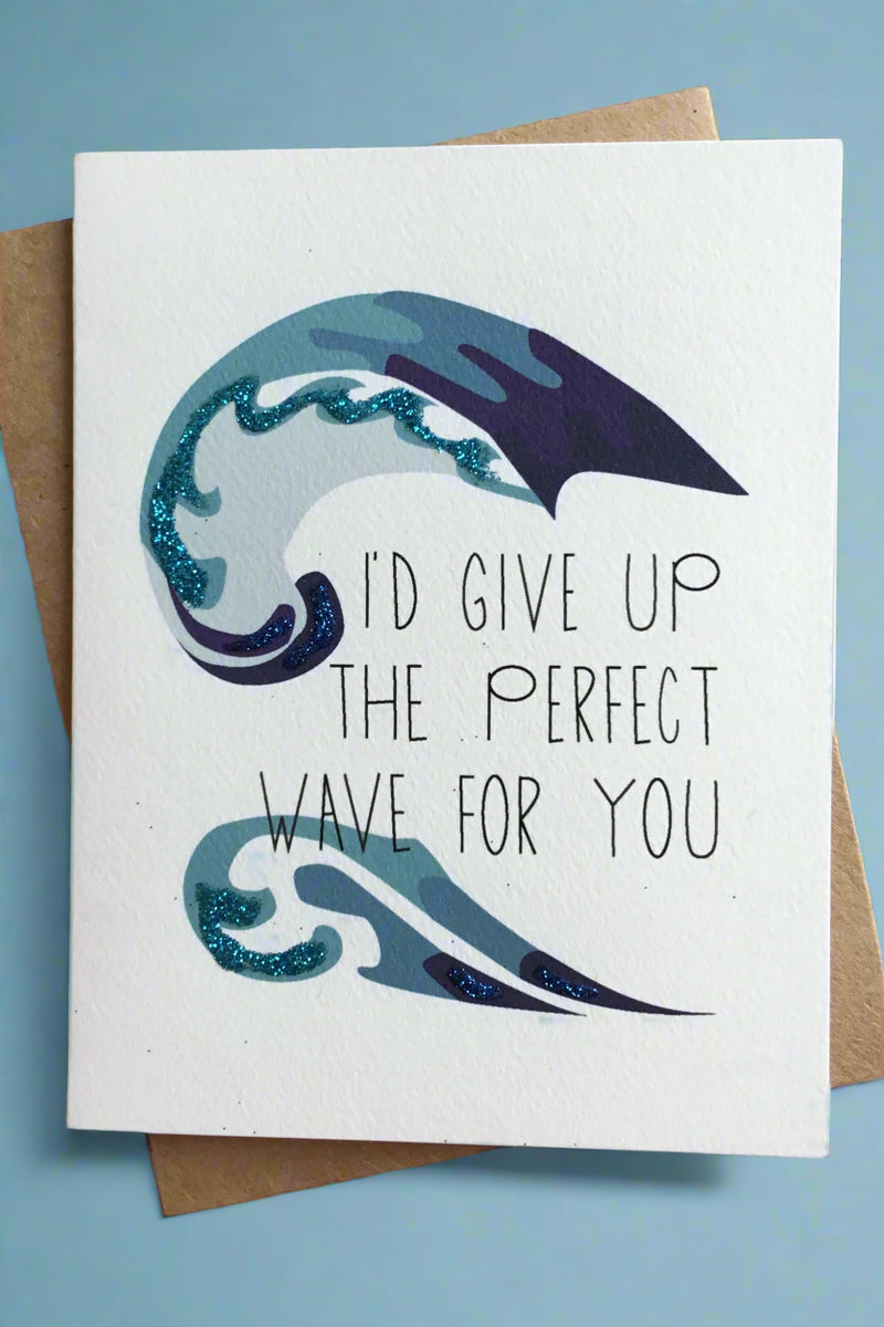An ivory card with waves and the words “I’d give up the perfect wave for you.”