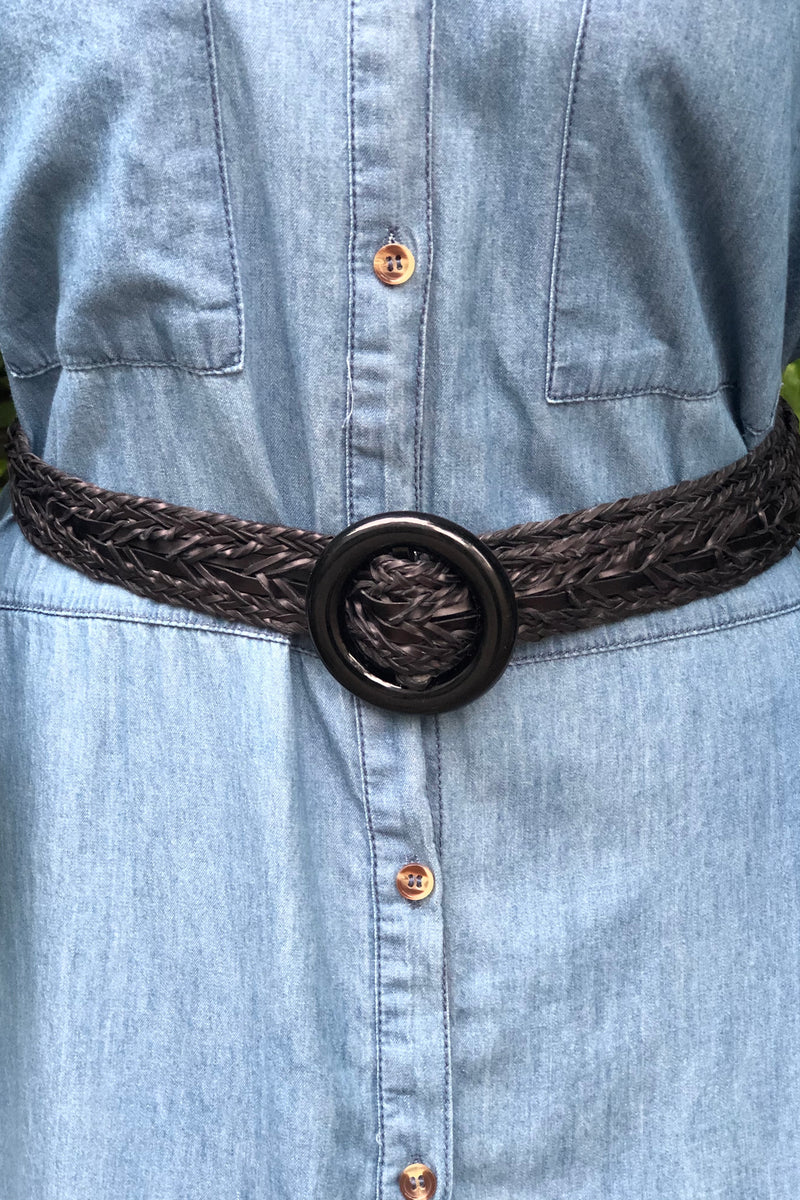A black braided belt with a pul through buckle for adjustable sizes.